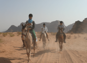 Debby van den Helder learning horse riding in the desert